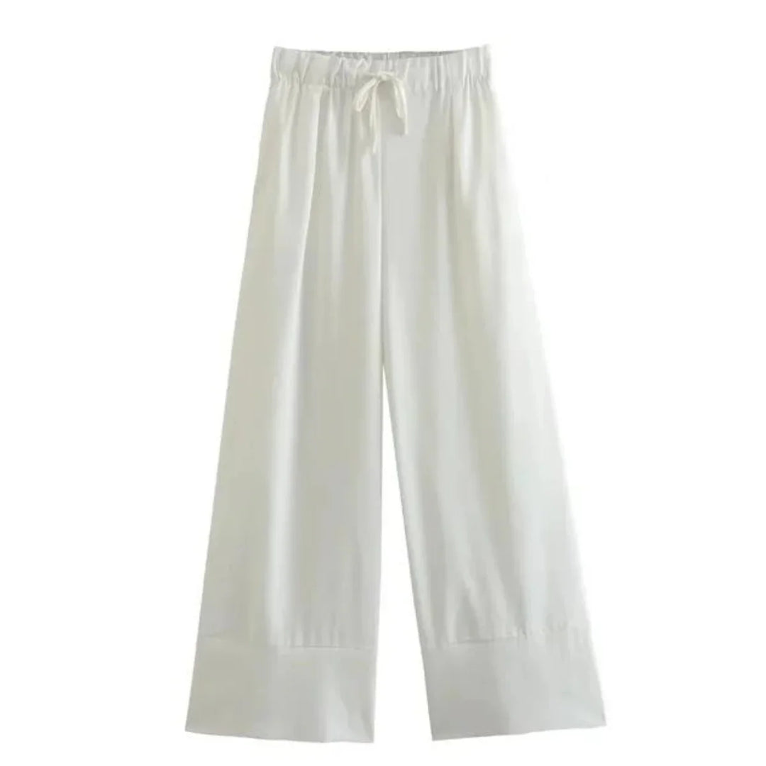Wide-leg white pants with an elastic waistband and drawstring tie, perfect for a relaxed summer style. Displayed on a plain background, these wide-leg pants feature a loose fit and simple design.