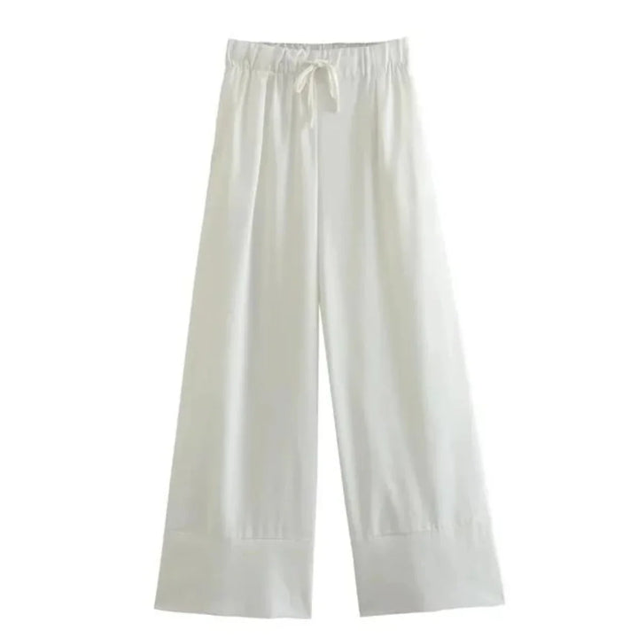 Wide-leg white pants with an elastic waistband and drawstring tie, perfect for a relaxed summer style. Displayed on a plain background, these wide-leg pants feature a loose fit and simple design.