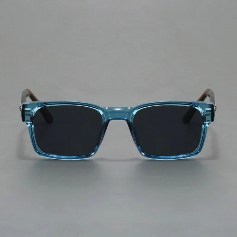 A pair of rectangular sunglasses with light blue translucent, durable frames and black lenses, offering UV400 protection, shown against a plain gray background.