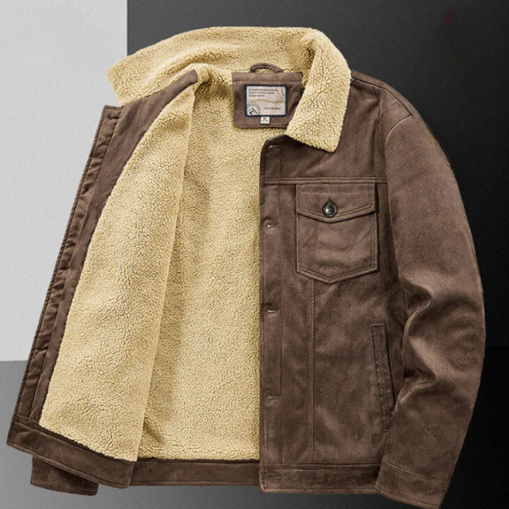 A brown suede jacket with a structured fit, beige sherpa fleece lining, buttoned front, one chest pocket with a button, and long sleeves, displayed open on a black and white background.