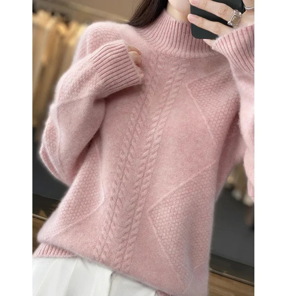 Woman wearing soft pink cable knit sweater from Rovelli