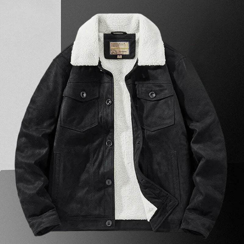 A black suede jacket with a white sherpa fleece collar and inner lining, featuring a structured fit, buttoned chest pockets, and front buttons, displayed on a color-blocked background.