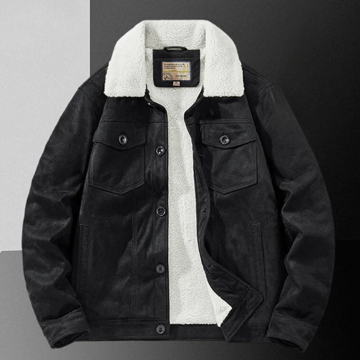A black suede jacket with a white sherpa fleece collar and inner lining, featuring a structured fit, buttoned chest pockets, and front buttons, displayed on a color-blocked background.