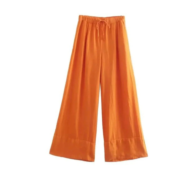 Wide-leg orange pants with an elastic waistband and drawstring, made of lightweight fabric, perfect for a breezy summer style. Displayed on a plain white background.