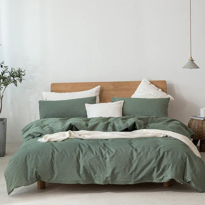 Modern bedroom with green duvet bedding set, wood bed frame, and minimalist decor by Rovelli