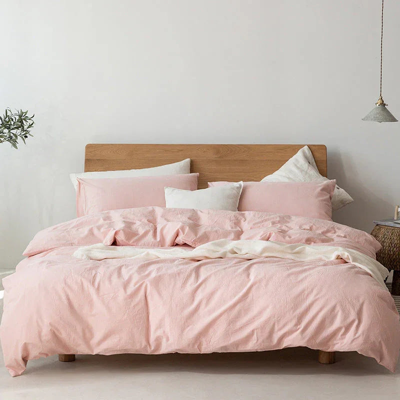 Rovelli modern bedroom with pastel pink bedding, light wood headboard, and minimalist decor