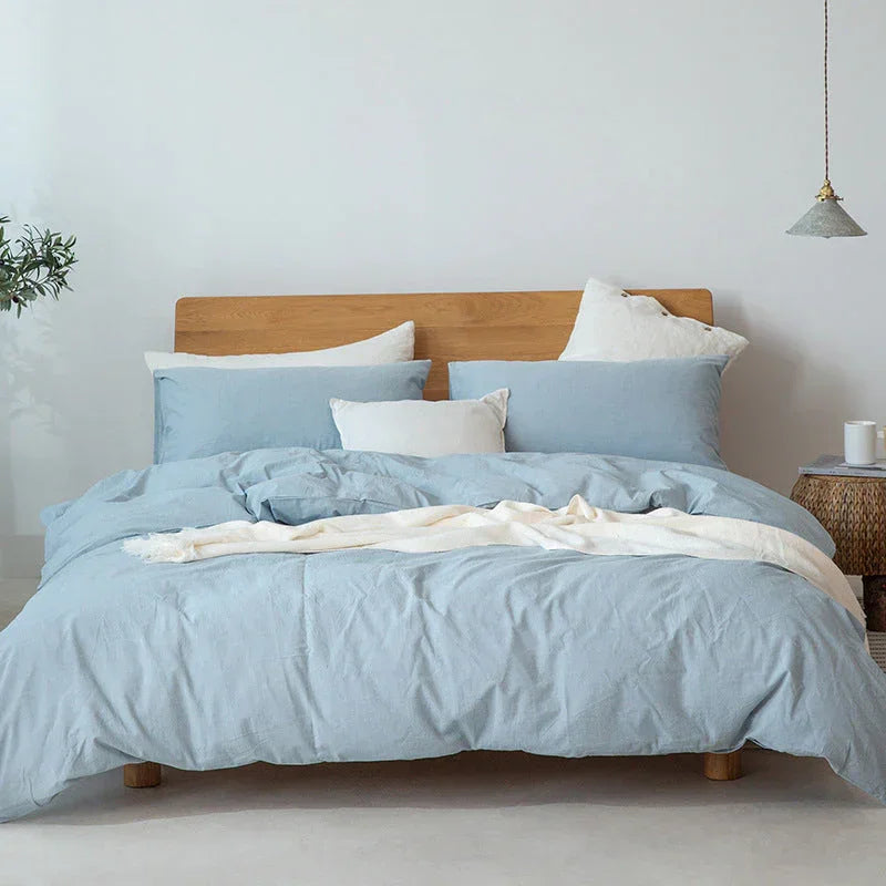 Light blue bedding set on a wooden bed frame in a modern Rovelli bedroom