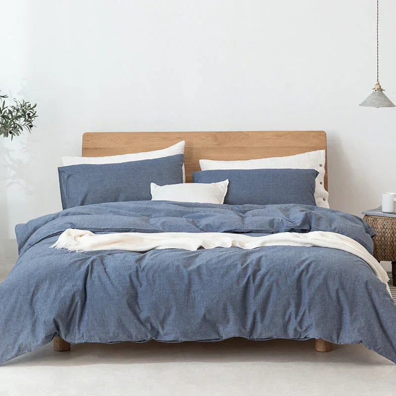 Modern bedroom with wooden bed frame, blue and white bedding set, and minimalist decor at Rovelli