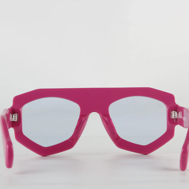 Bright pink futuristic sunglasses with thick geometric acetate frames and light-tinted lenses, featuring UV400 protection, shown facing forward against a plain white background.