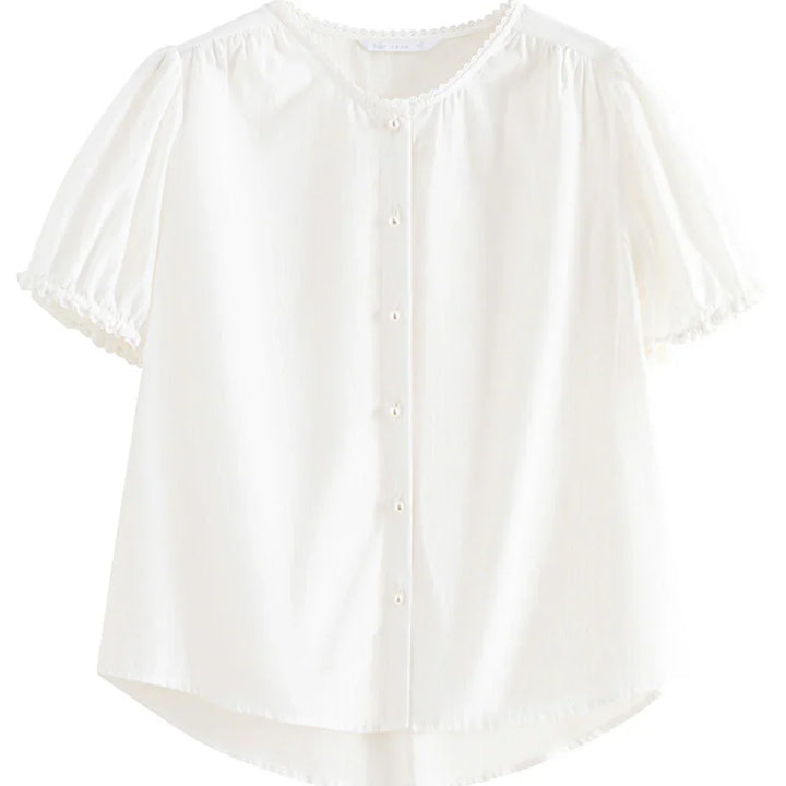 A white lace trim blouse featuring short puffed sleeves, a round neckline, small white buttons down the front, and delicate lace on the cuffs and collar—perfect as a versatile blouse for any occasion.