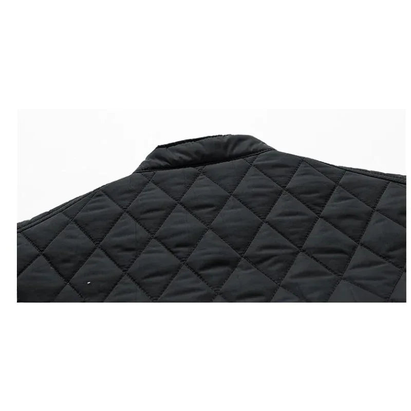Close-up of the upper back of a black, wind-resistant quilted jacket with a diamond pattern and a short, standing collar.