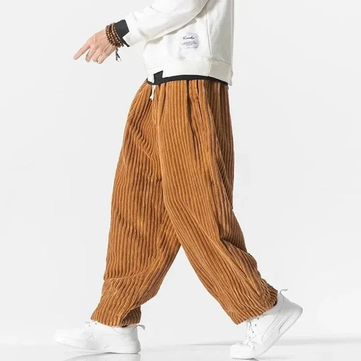 Rovelli wide-leg corduroy pants in brown, styled with white sneakers and a white sweatshirt