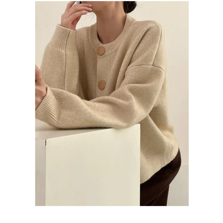 Woman wearing a beige knit sweater with large buttons, Rovelli minimalist fashion