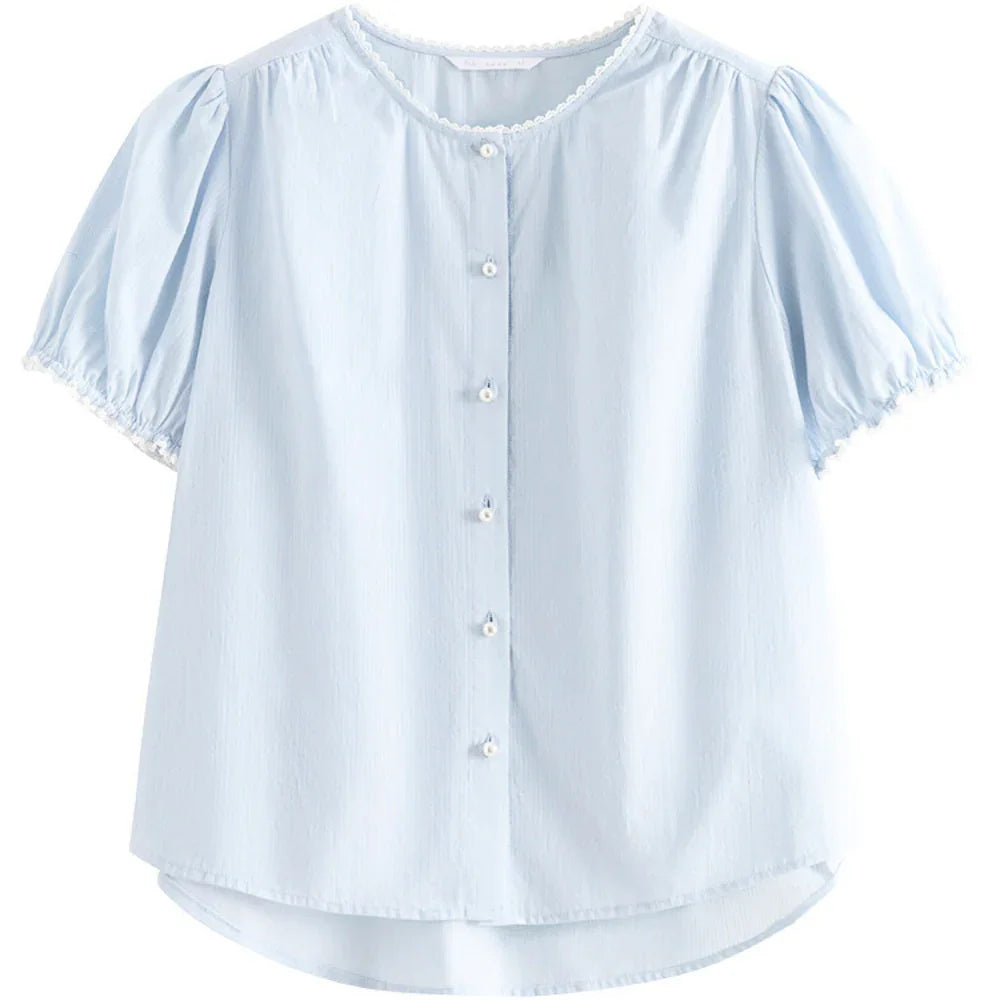 Light blue short-sleeved button-up blouse with puffed sleeves, white decorative trim at the collar and sleeve edges, and a slightly curved hem. This versatile blouse features soft, lightweight fabric for all-day comfort.