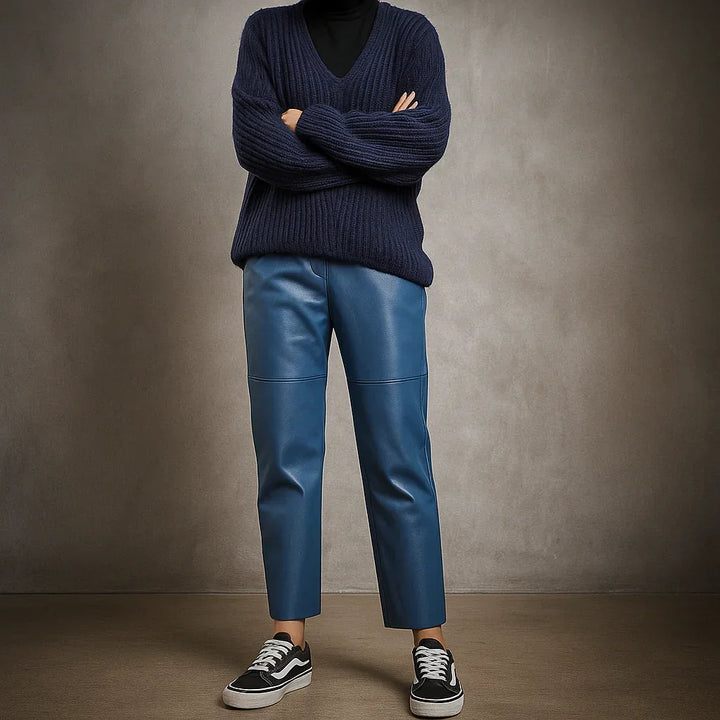 Rovelli blue leather pants paired with navy sweater and sneakers, studio background