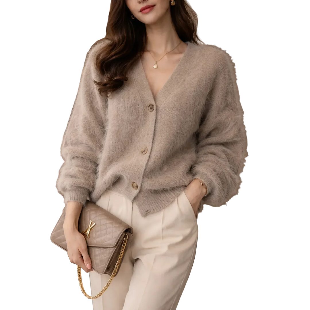 Woman in beige fuzzy cardigan and cream pants holding quilted purse, Rovelli fashion