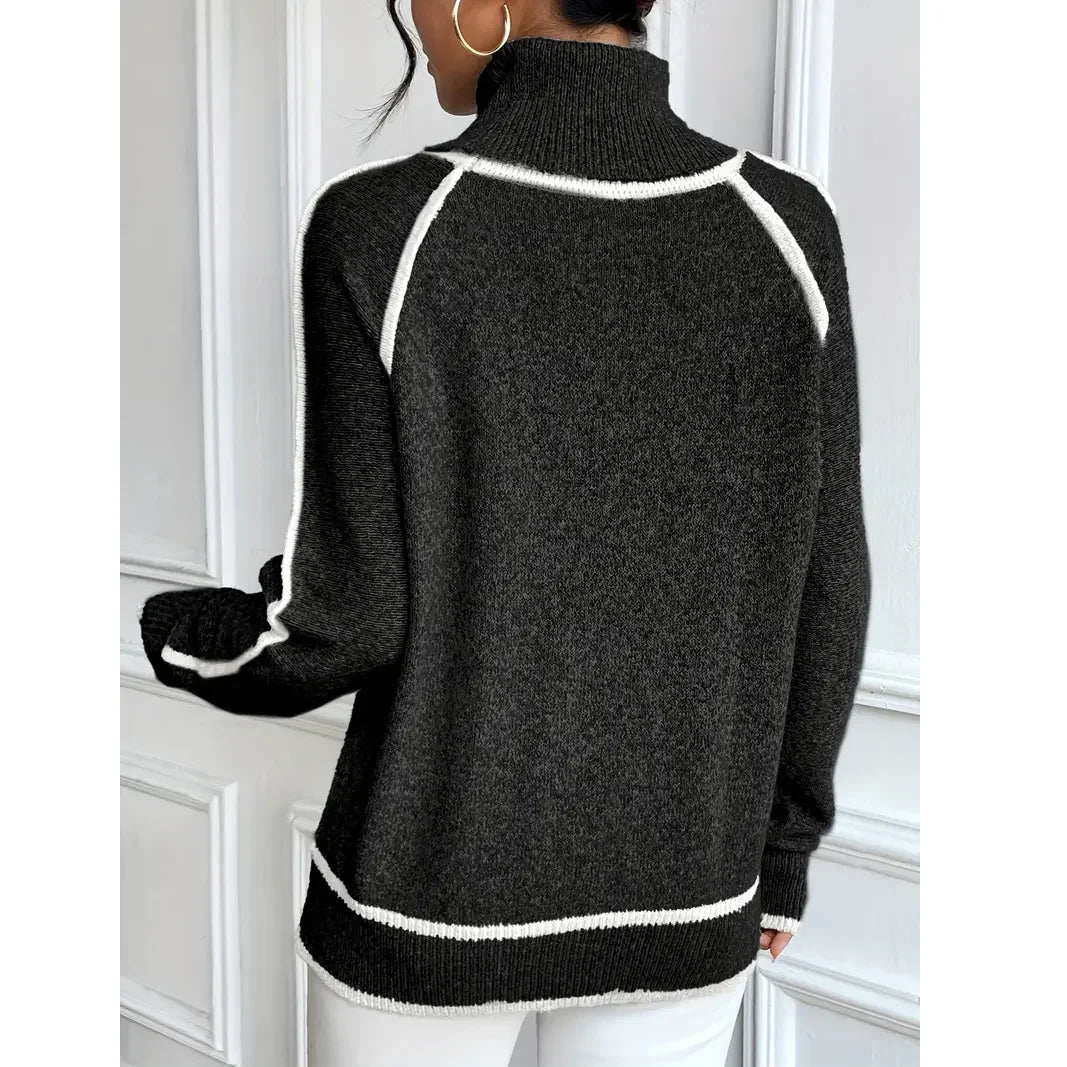 Rovelli dark knit turtleneck sweater with white trim, worn by woman indoors