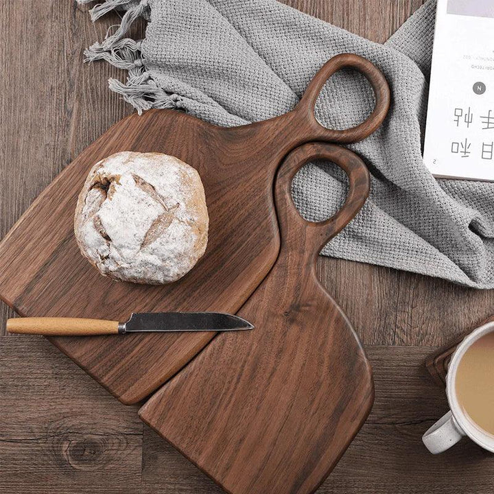 Rovelli wooden cutting boards with bread, knife, and coffee on a rustic table