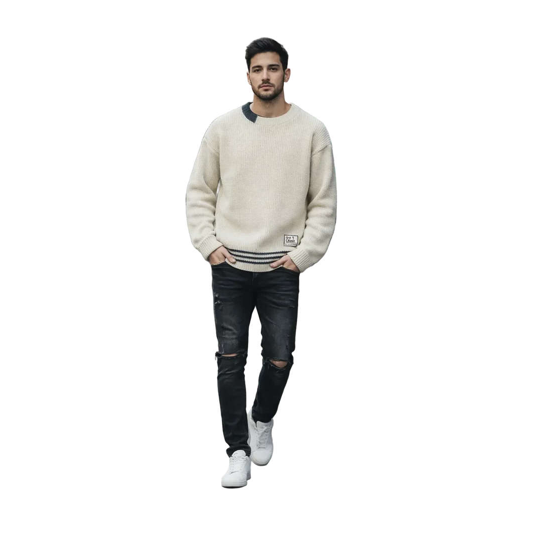 Man in cream sweater and black ripped jeans, Rovelli fashion, on black background