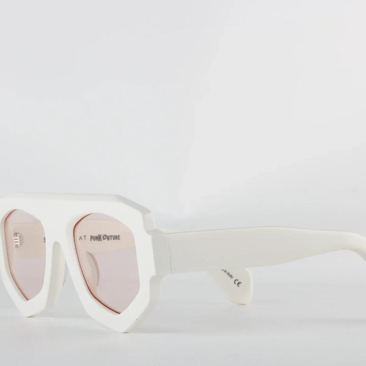 White oversized sunglasses with a bold geometric frame crafted from acetate and light pink-tinted lenses. The thick, angular edges create a modern look, while UV400 protection ensures stylish sun safety against a plain white background.