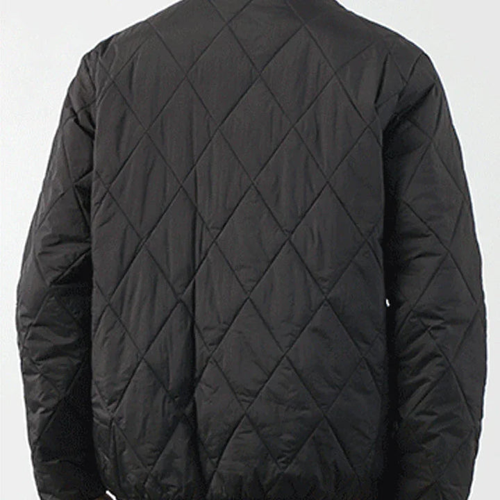 A person wearing a black padded jacket, shown from the back. The jacket features a diamond-stitched pattern and has a slightly loose fit. The background is plain and light-colored.