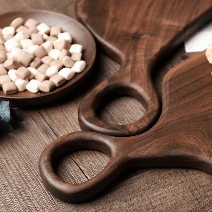 Rovelli walnut wood serving boards with candies on wooden table