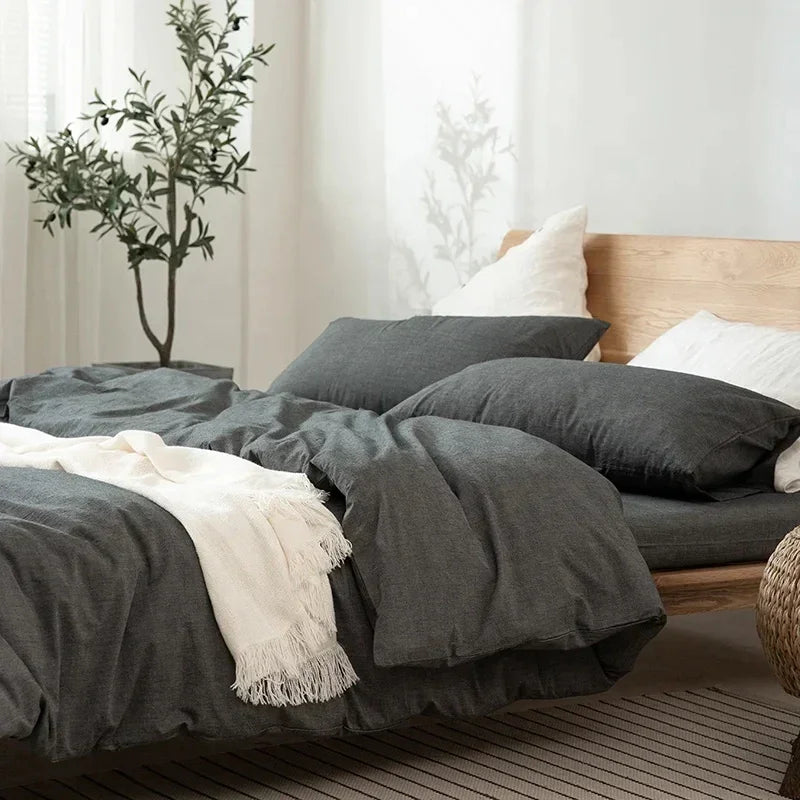 Modern bedroom with grey bedding, wooden bed frame, and indoor plant by Rovelli