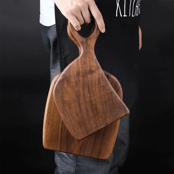 Hand holding two wooden cutting boards, kitchen apron, Rovelli store product