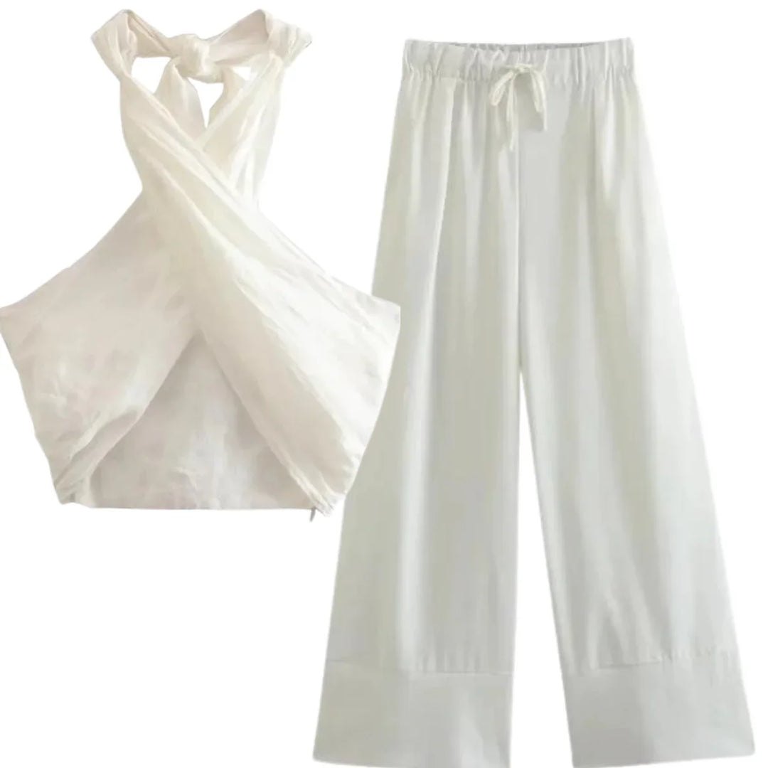 A chic halter collar defines this white sleeveless top with a crisscross front, paired effortlessly with loose, wide-leg pants featuring an elastic waistband and drawstring for easy summer style.