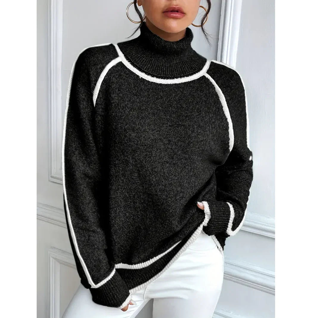 Woman wearing black turtleneck sweater with white trim, white pants, Rovelli fashion