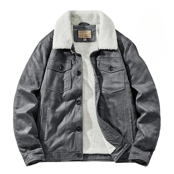 A gray suede jacket with a white, fluffy Sherpa lining and collar, front button closures, and two chest pockets with flaps. The jacket offers a structured fit and is laid flat on a white background.