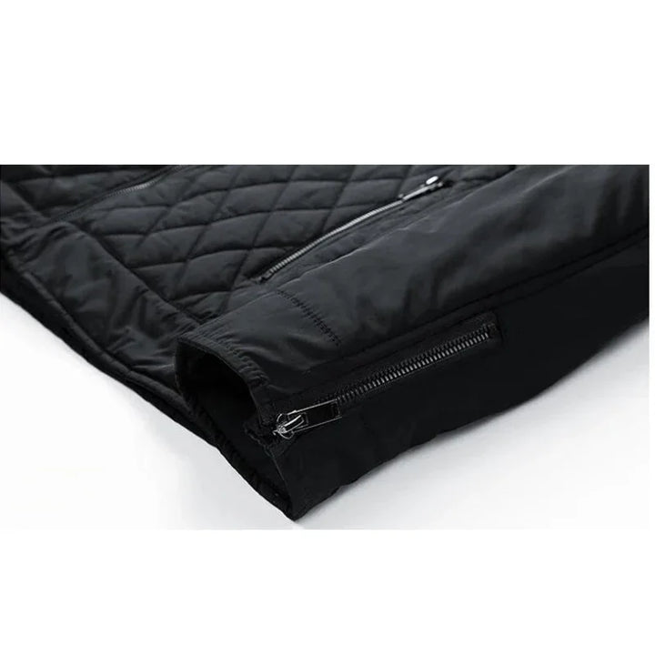 A close-up view of a black, wind-resistant quilted jacket sleeve with a visible zipper on the cuff and another zipper pocket above it, displayed on a white background.