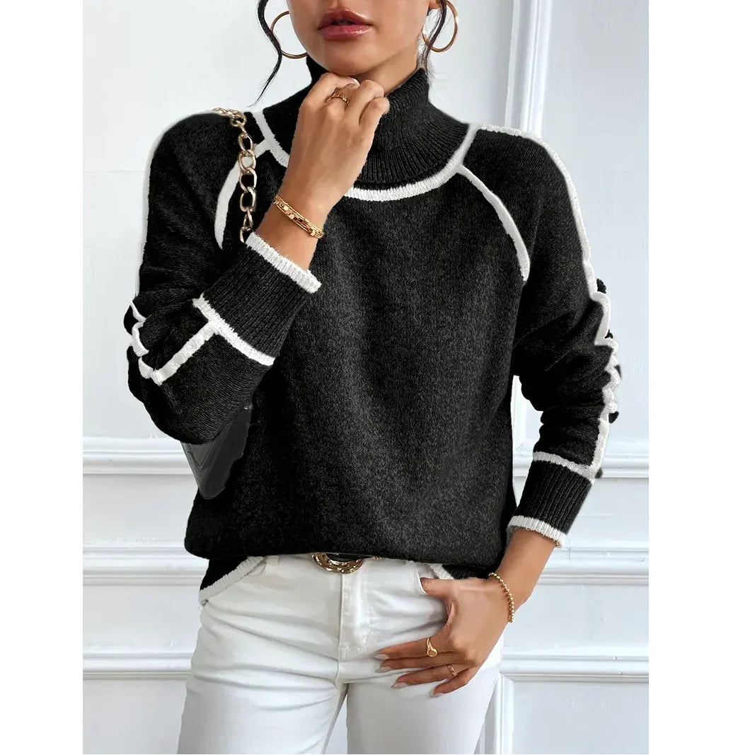 Woman wearing a black turtleneck sweater with white trim, paired with white pants, Rovelli fashion