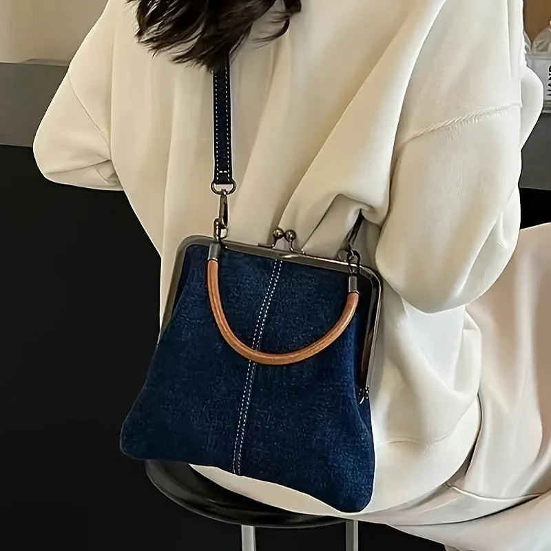 Woman wearing cream sweater with Rovelli dark blue denim handbag featuring wooden handle