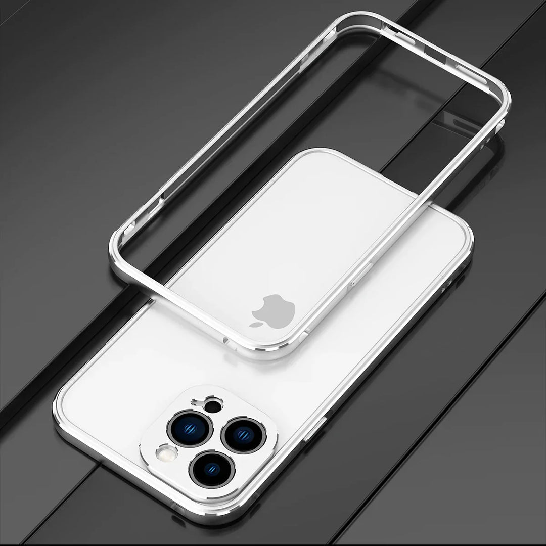 A white smartphone with a triple camera setup lies on a black surface. Above it, a durable phone case with transparent back and metallic edges highlights the phone’s camera features while offering drop protection.