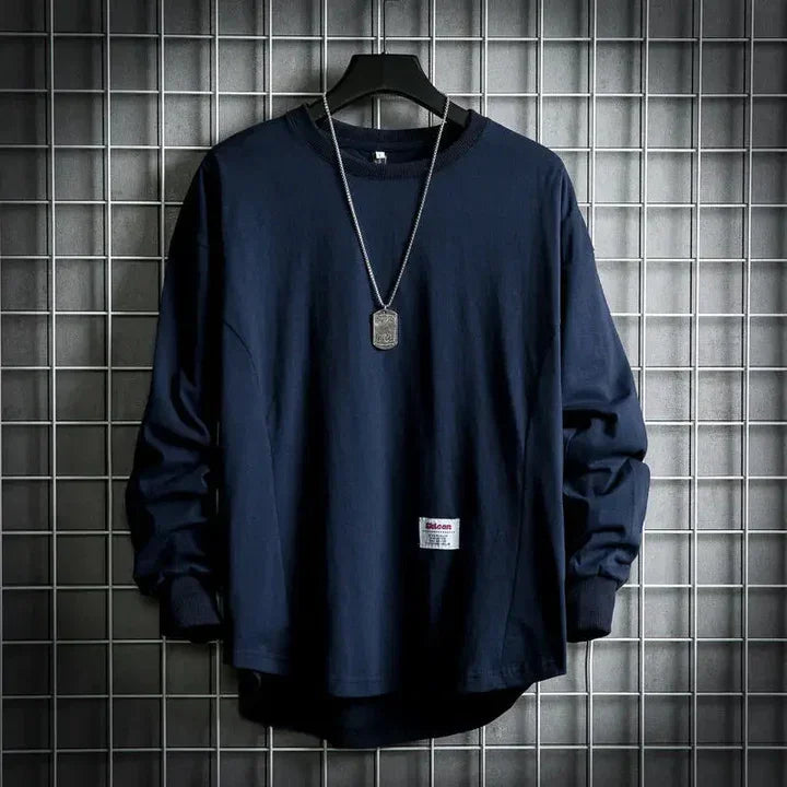 Navy blue Rovelli long sleeve shirt with necklace on hanger, grid wall background