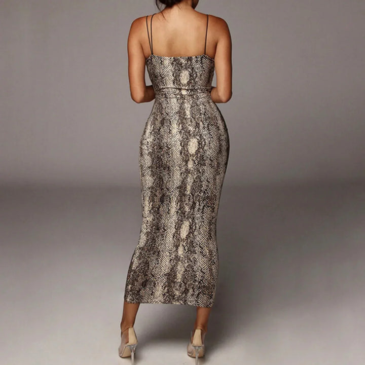 A woman stands facing away from the camera, wearing a fitted, sleeveless animal print dress with thin straps—an ideal summer statement dress—paired with neutral high-heeled shoes against a plain background.