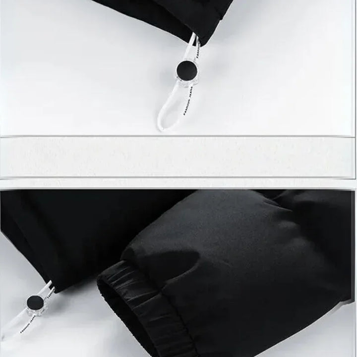 Close-up of a black jacket sleeve featuring a white adjustable drawcord with a black circular toggle and elastic cuff, displayed on a white surface. The jacket boasts premium insulation for added warmth.