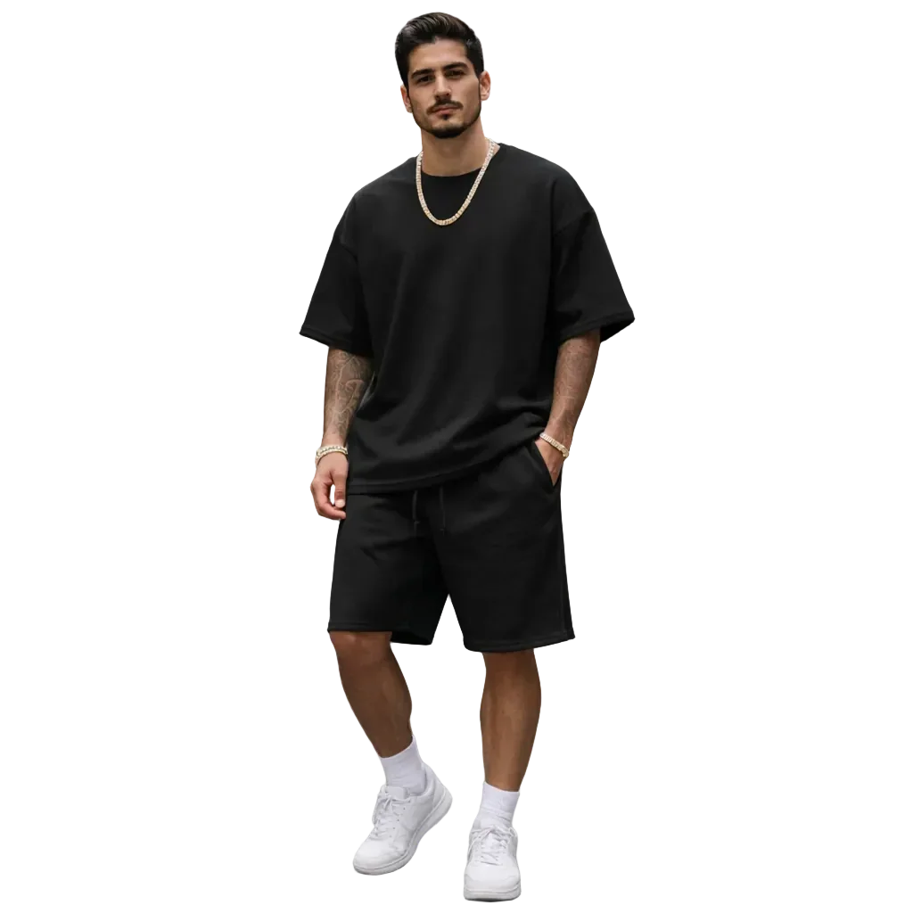Man wearing black oversized t-shirt and shorts set with gold chain, white sneakers, Rovelli style
