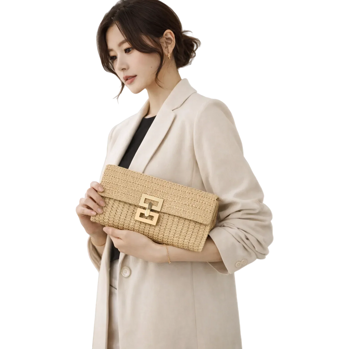 Woman in beige blazer holding Rovelli woven clutch bag with gold buckle