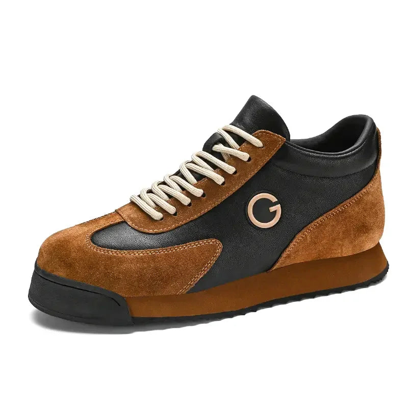 A stylish sneaker for the urban professional, featuring luxe leather suede in brown, cream-colored laces, a black sole, and a metallic circular G logo on the side.