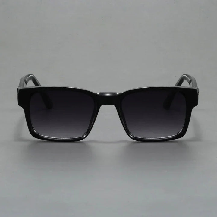 A pair of black square-framed sunglasses with durable frames and dark tinted lenses, featuring modern design and UV400 protection, displayed against a plain grey background.