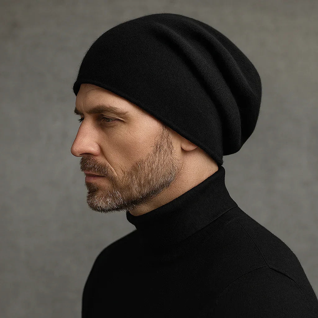 Man wearing Rovelli black cashmere beanie and black turtleneck against gray background