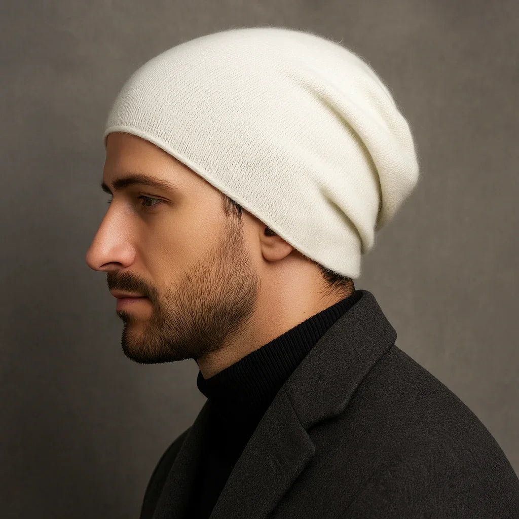 Man wearing Rovelli white cashmere beanie against gray background