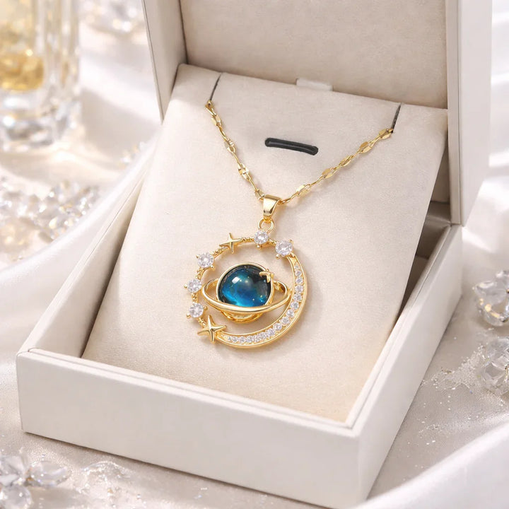 Gold planet and stars pendant necklace with blue gemstone in jewelry box, Rovelli jewelry