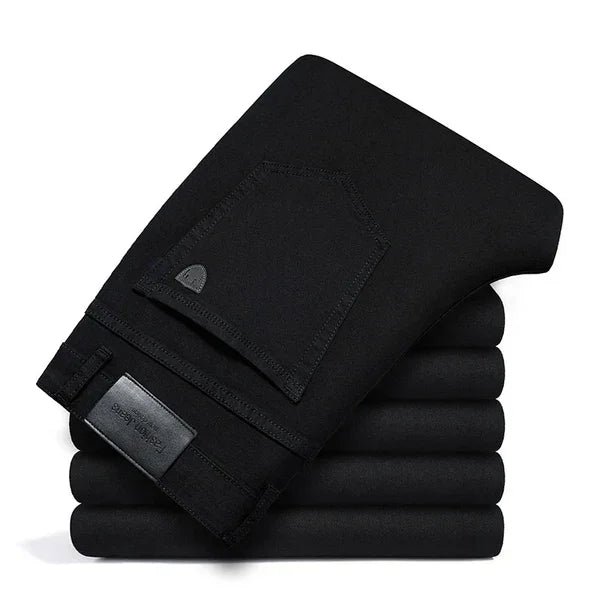 Folded black pants stack with visible back pocket, Rovelli elegant modern clothing