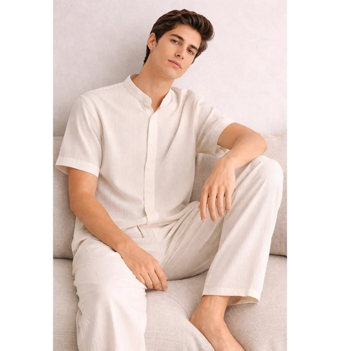 Man wearing beige textured lounge set sitting on sofa, Rovelli clothing collection