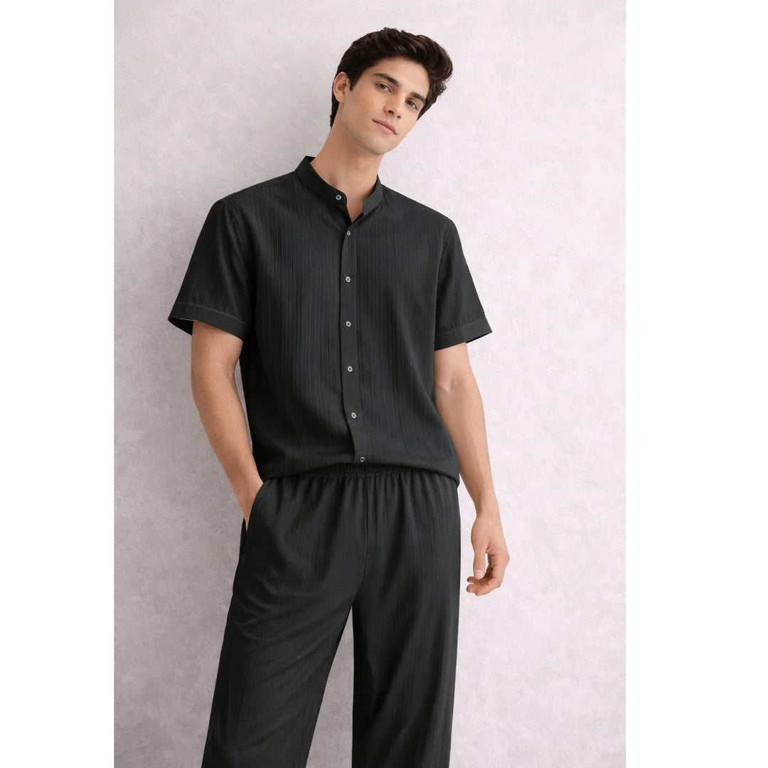 Man wearing Rovelli black textured lounge set with short sleeves and button-up shirt