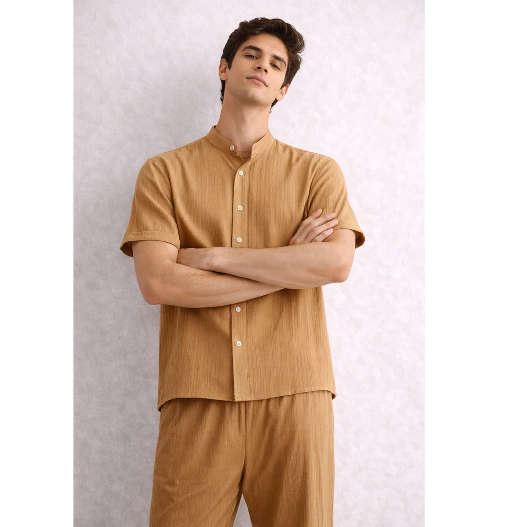 Man wearing brown textured lounge set from Rovelli with short sleeves and button-down shirt