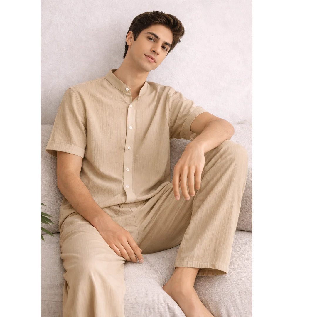 Man lounging in khaki textured lounge set from Rovelli on a neutral sofa